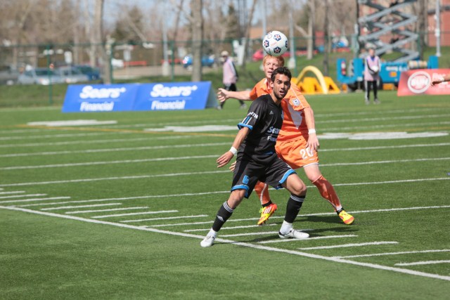 Hat-trick goal scorer Shaun Saiko wins a ball against a RailHawks defender Hat-trick goal scorer Shaun Saiko wins a ball against a RailHawks defender